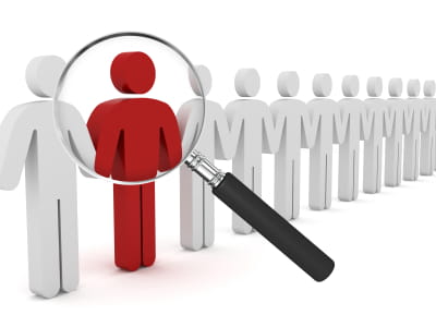 red figure in a white line-up, magnifying glass